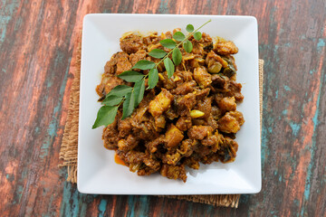 Spicy hot meat curry from Kerala India. Pork pig masala curry vindaloo. Indian food served rice, appam popular Lankan, Thailand, Malaysia, Asian. Indian spices, goulash, fry