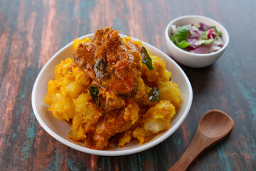 tapioca and spicy hot Kerala fish curry Indian food. Kappa king fish masala curry. Asian cuisine Bengali macher Jhal Goan fish curry in coconut milk Cassava root , Mandioca Sri Lanaka Tamil nadu