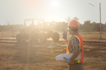 Worker  holding radio operate and control the worker employee to road construction. Young  road...