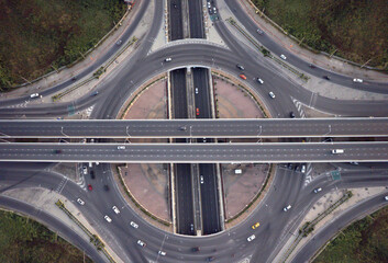 Drone aerial view of elevated roads and city traffic intersections, modern design of roads and solve and avoid traffic jams in the city.