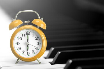 Retro alarm clock stand on vintage piano