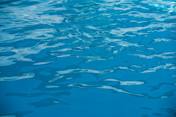 Fototapeta na wymiar Blue ripped water in swimming pool, water pool texture and surface water backgraund.