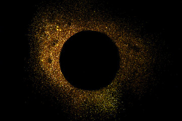 Dark texture with a round sprinkling of gold. Backdrop with golden sparkle for frame, copy space,...