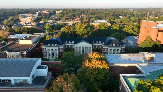 University of Georgia, UGA college campus buildings in Athens GA. Aerial pullback reveal during magic hour light.