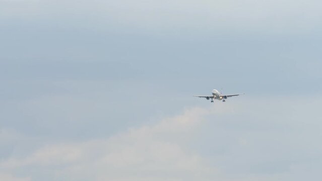 Jet airplane approaching to land at Phuket airport. Long shot, jet airplane descending