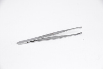 tweezers on white background