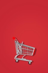 Classic shopping cart on color background