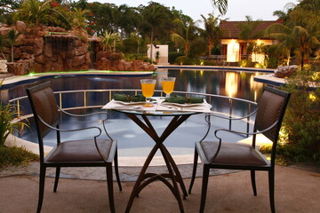 Romantic sunset dinner at a a resort by the pool