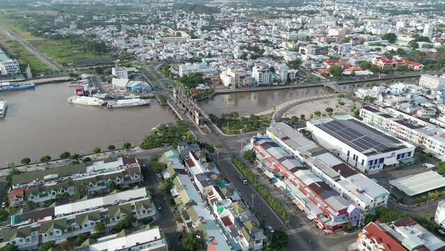 Aerial drone footage above Rach Gia coastal city in south vietnam. Drone is moving foward along the seaside to the city center 1-2