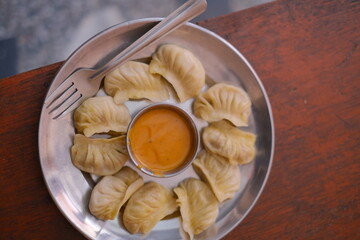 Nepalese momo dumplings with hot sauce.