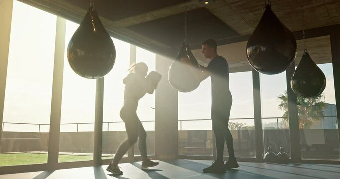 Sports, boxing and woman with personal trainer in gym doing exercise, workout and practice in the morning. Fitness, cardio and female athlete training with coach in kickboxing lesson for wellness