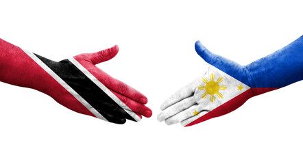 Handshake between Philippines and Trinidad Tobago flags painted on hands, isolated transparent image.