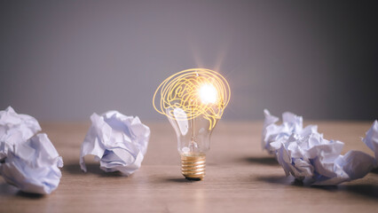 Education concept image. Creative idea and innovation. Crumpled paper as light bulb metaphor over