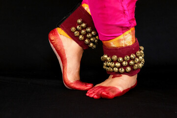 Bharatanatyam Indian classical dancer legs in closeup view demonstrating dance mudra or gestures.