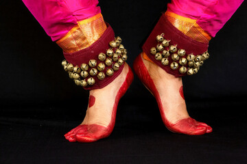 Female Indian classical dancer legs in closeup view demonstrating dance mudra or gestures.