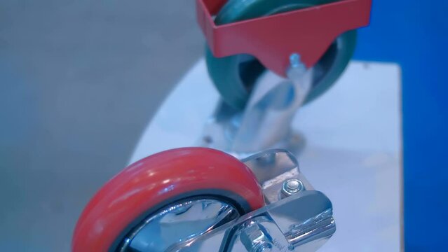 Samples of new powerful rollers for industrial trolley at the exhibition of industrial equipment. Shot in motion. Closeup