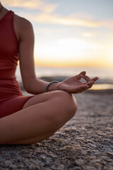 Hand, woman and yoga at the beach at sunset, zen and relax exercise, mudra and chakra training with mockup. Meditation, hands and girl meditating at the sea, peace and energy in nature environment