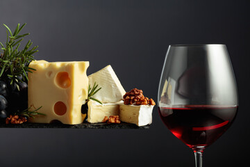 Red wine with cheese, walnuts, grapes, and rosemary.