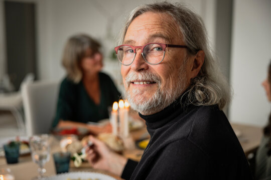 Portrait of senior man having dinner with family