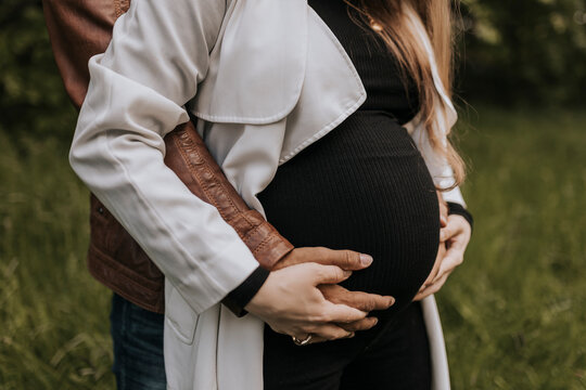 Pregnant woman with partner standing together