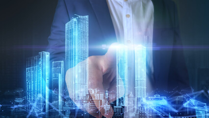 Business man press the Hologram technology city town on the screen concept technology background using data tech devices