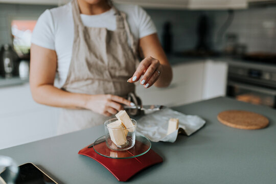 Woman weighting butter