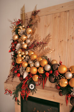 New Year's Decor By The Fireplace In Red And Gold Shades