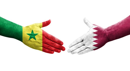 Handshake between Qatar and Senegal flags painted on hands, isolated transparent image.