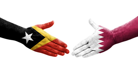 Handshake between Qatar and Timor Leste flags painted on hands, isolated transparent image.