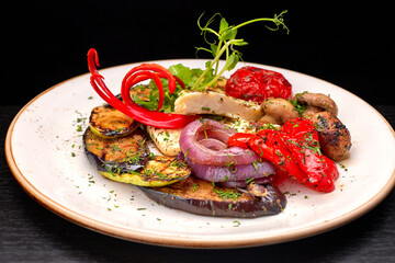Baked vegetables with mushrooms and cheese on a plate