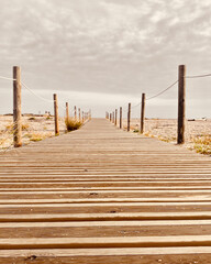 Fototapeta premium Wooden path with the beach with the sea in the background.summer beach concept.