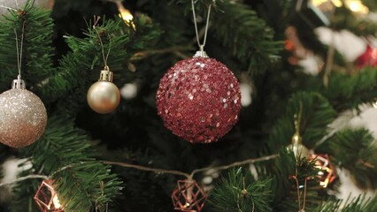 Christmas tree decorates with glitter balls and bulbs garlands for family holiday. Happy New Year Festival mood. vertical panning video 4K - Powered by Adobe