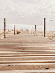 Fototapeta na wymiar Wooden path with the beach with the sea in the background.summer beach concept.
