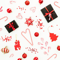 Christmas composition with gifts, decoration, toys, candy canes and confetti on white.