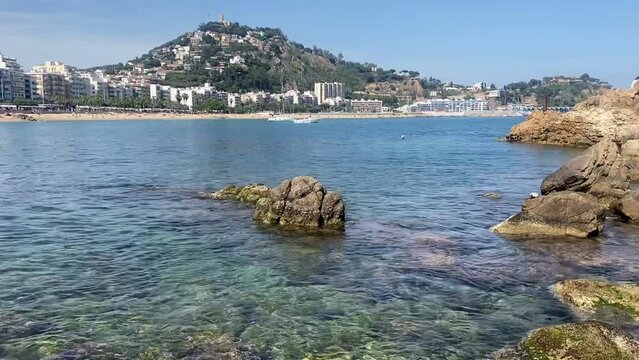 Blanes beach on the Costa Brava. Turquoise crystalline waters of the Mediterranean Sea. Costa brava tourist beaches. Catalonia, Spain.