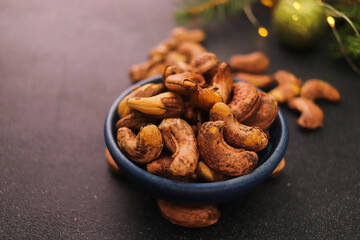 cashew nuts close-up in a bowl on a dark background selective focus