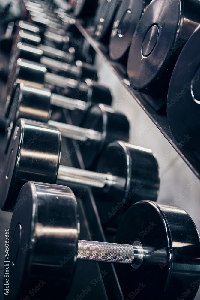 Sticker Fitness, workout and dumbbells in an empty gym for exercise, body building development or strength training for wellness. Commitment, motivation or heavy metal weights for strong arms or body muscles