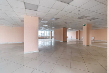 An empty office room with columns and large panoramic windows