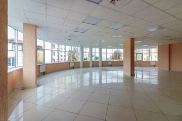 An empty office room with columns and large panoramic windows
