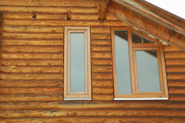 Windows of cozy wooden house outdoor in winter season