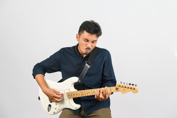 Portrait of Young Asian man in blue shirt with electronic guitar isolated on white background