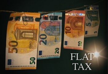 Close up of European Banknotes with the text "Flat Tax"
