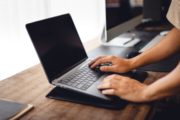 Close up of businessman working and login on laptop