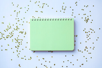 Light green blank notepad on christmas background with sparkles