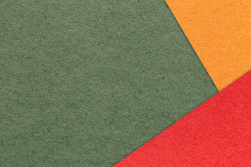 Craft dark olive color paper background with red and orange border. Vintage green cardboard....