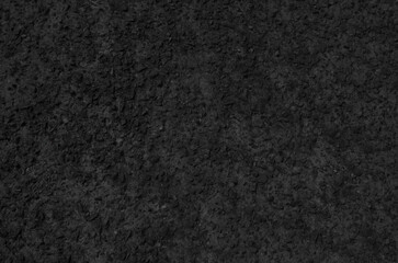 Fototapeta premium Black washed out earthen floor texture background. Pebble-filled road surface.