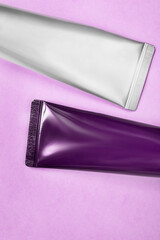 Cosmetic tubes on purple