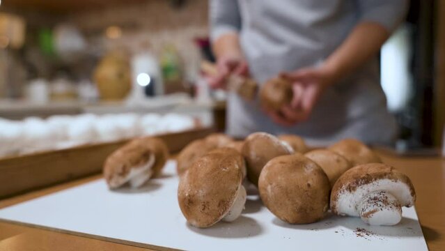 The confectioner dusts the champignons marshmallow with cocoa powder. Handmade