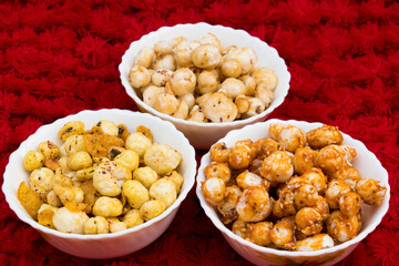 Crispy, healthy and homamade Phool Makhana or Fox Nuts snacks platter. It contain caramel makhana with jaggery, with sugar and Makhana mixture having peanut and cornflakes.