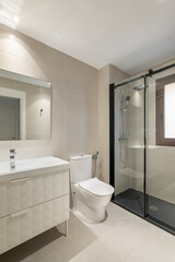 Modern empty bathroom with beige tiles, furniture and rectangular mirror